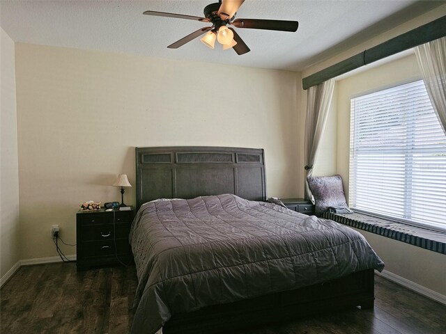 bedroom featuring dark wood-type flooring and ceiling fan