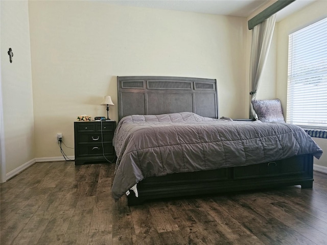 bedroom with dark hardwood / wood-style floors