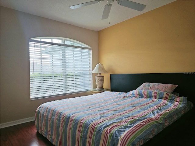 bedroom with ceiling fan and dark hardwood / wood-style floors