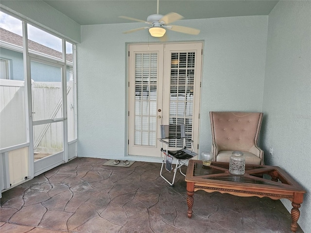 living area featuring french doors and ceiling fan