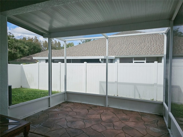 unfurnished sunroom with lofted ceiling