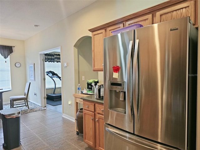 kitchen with stainless steel fridge and light tile patterned floors