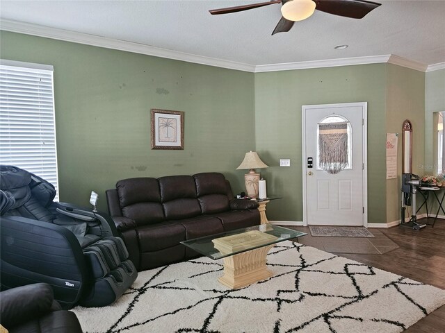 living room with ornamental molding, dark hardwood / wood-style flooring, and ceiling fan