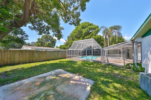 3908 W Wallace Ave, Tampa, FL 33611 - view of yard with a patio area, a fenced backyard, a fenced in pool, and a lanai