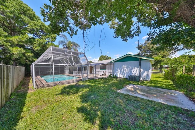 3908 W Wallace Ave, Tampa, FL 33611 - exterior space featuring a lanai, an outdoor pool, a fenced backyard, and a patio area