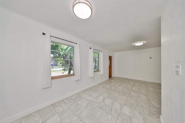 3908 W Wallace Ave, Tampa, FL 33611 - unfurnished room with baseboards and marble finish floor