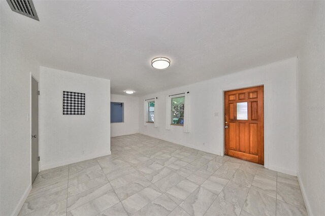 3908 W Wallace Ave, Tampa, FL 33611 - unfurnished room featuring visible vents, baseboards, and marble finish floor