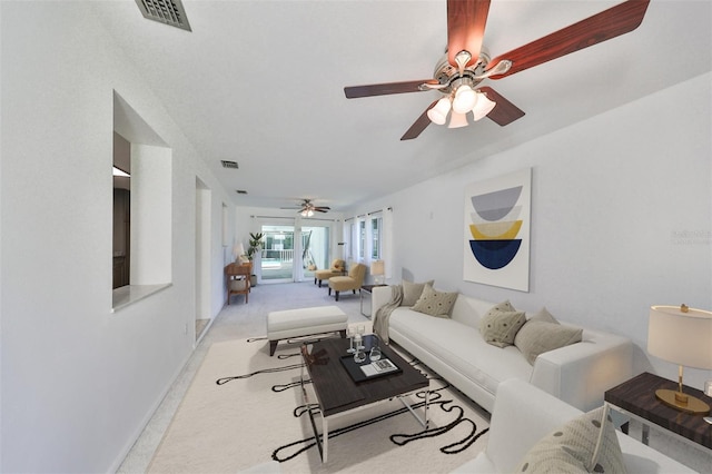 3908 W Wallace Ave, Tampa, FL 33611 - carpeted living room with visible vents and a ceiling fan