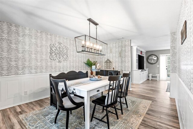 dining room with a notable chandelier and hardwood / wood-style floors