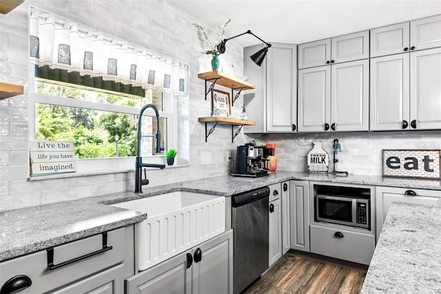 kitchen with dark wood-style floors, appliances with stainless steel finishes, a sink, open shelves, and backsplash