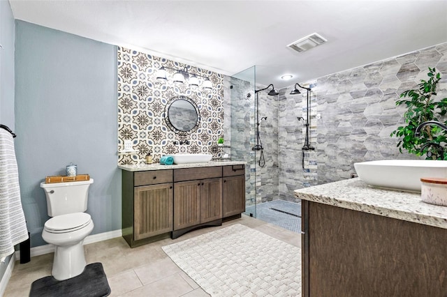 full bathroom with tile patterned flooring, toilet, vanity, visible vents, and a tile shower