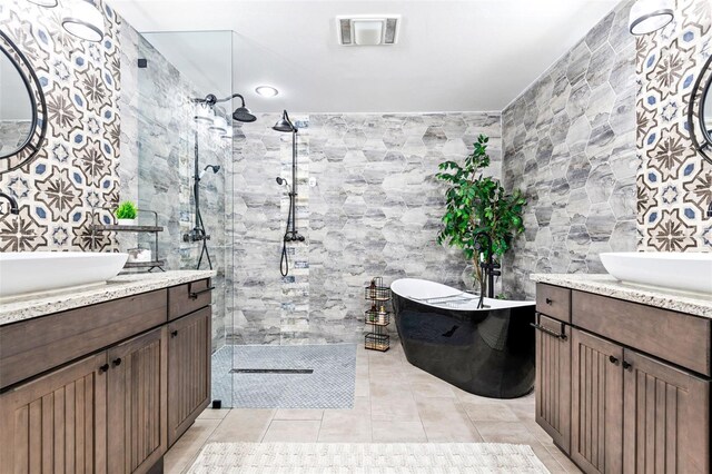 bathroom featuring vanity, tile walls, and shower with separate bathtub