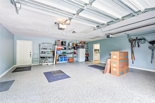 garage with white refrigerator and a garage door opener