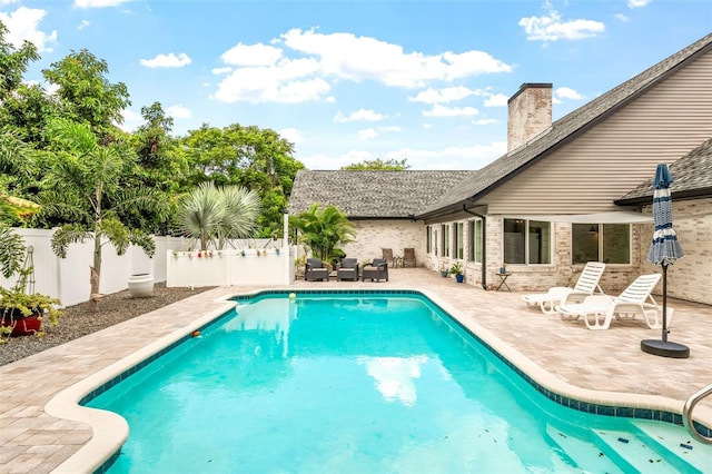 view of pool featuring a patio area