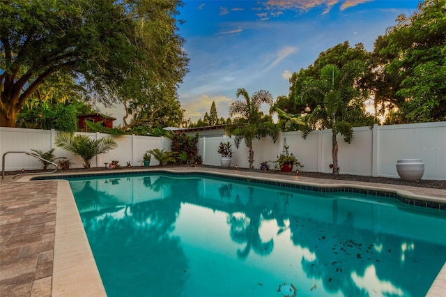 view of pool at dusk