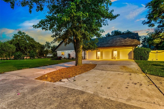 view of front of property with a yard and a garage