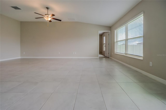 empty room with lofted ceiling, ceiling fan, and light tile patterned flooring