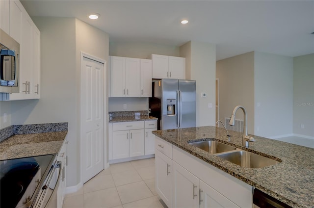 kitchen featuring light tile patterned floors, stainless steel appliances, sink, light stone counters, and white cabinets