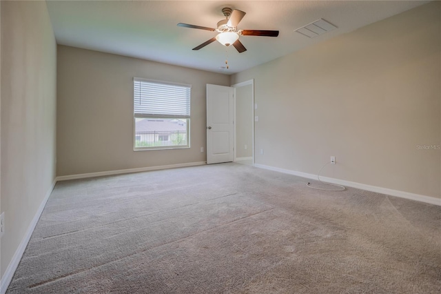 carpeted spare room featuring ceiling fan