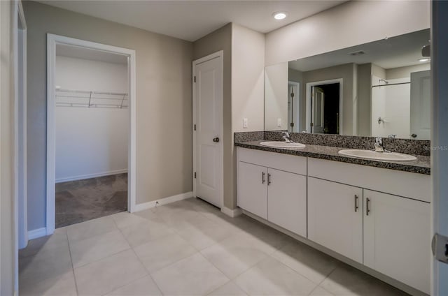 bathroom with vanity, tile patterned floors, and walk in shower