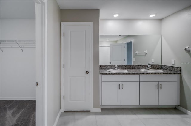 bathroom featuring tile patterned flooring and vanity