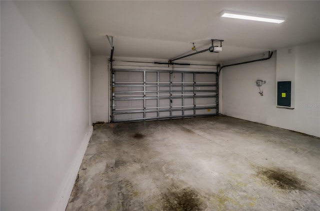 garage featuring electric panel and a garage door opener