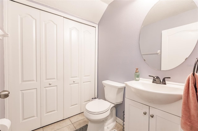 bathroom with vanity, toilet, and tile patterned floors