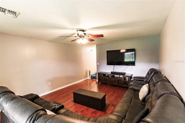 living room with hardwood / wood-style floors, ceiling fan, and a textured ceiling