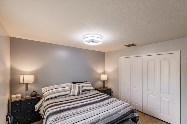 bedroom featuring a closet and a textured ceiling