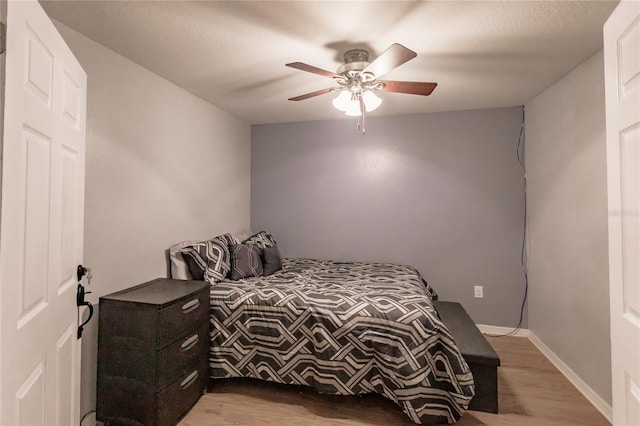 bedroom featuring hardwood / wood-style floors and ceiling fan