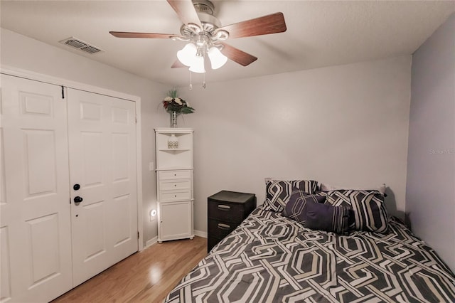 bedroom with a closet, ceiling fan, and light hardwood / wood-style floors