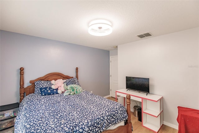 bedroom with wood-type flooring