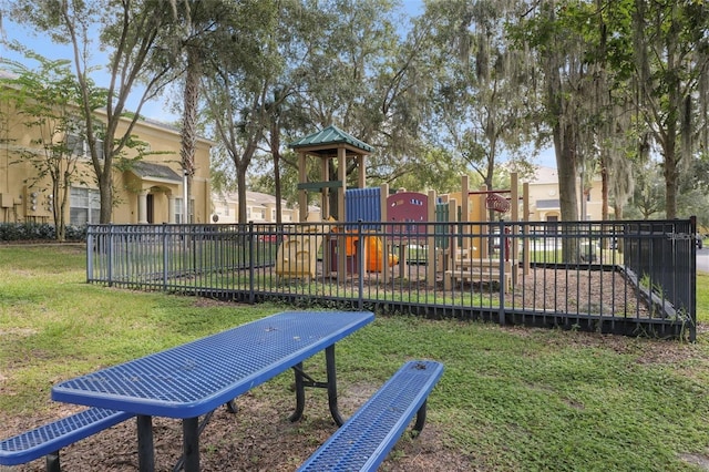 exterior space with a playground and a lawn