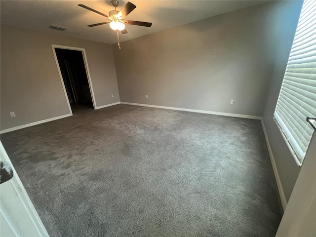 carpeted spare room with ceiling fan