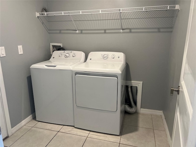 laundry area featuring light tile patterned floors and washer and dryer