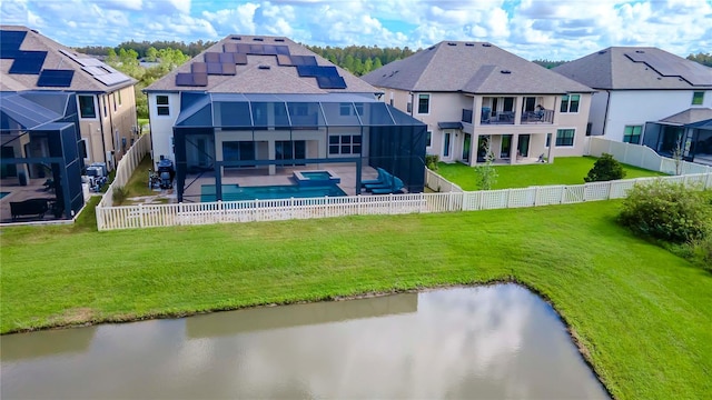 back of property with a patio, a fenced in pool, a balcony, glass enclosure, and a lawn