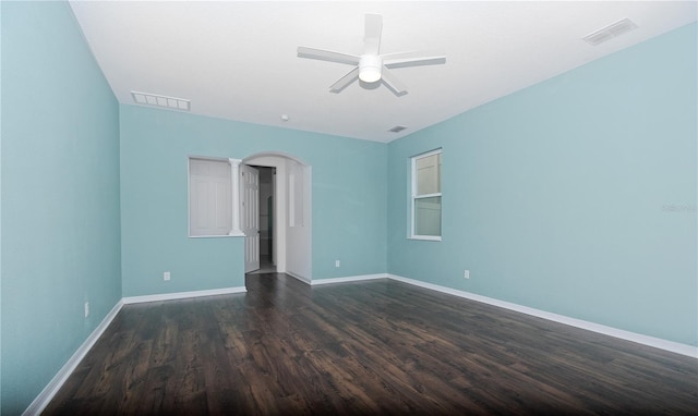 empty room featuring ceiling fan and dark hardwood / wood-style floors