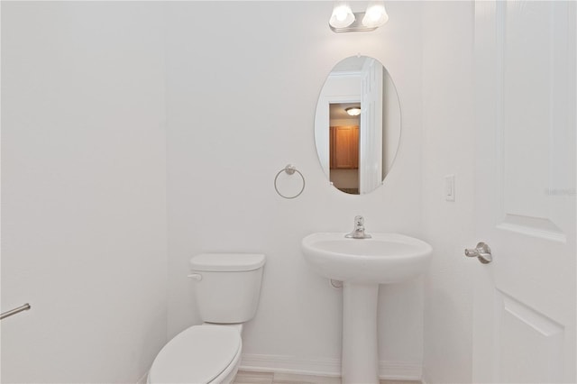 bathroom featuring sink and toilet