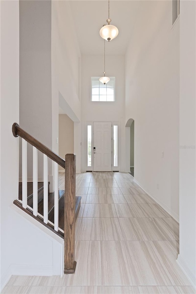 foyer entrance with a towering ceiling