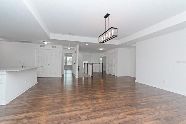 unfurnished living room featuring dark wood-type flooring