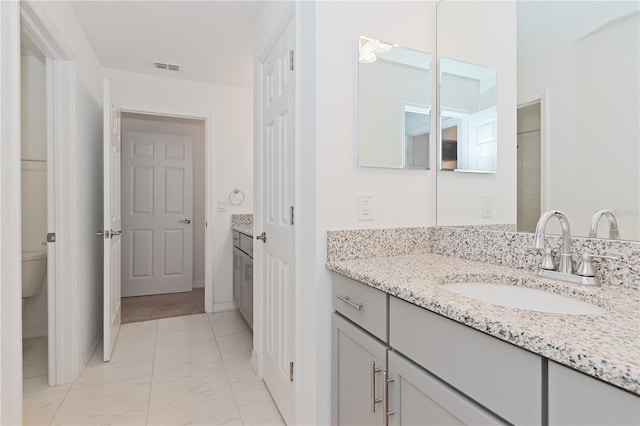 bathroom featuring toilet and vanity