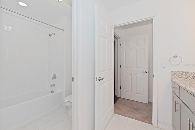 full bathroom with vanity, tiled shower / bath combo, and toilet