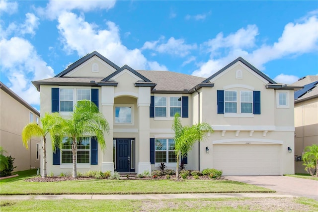 view of front of house featuring a front yard and a garage