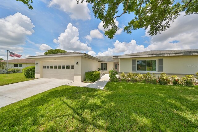 single story home with a front yard and a garage