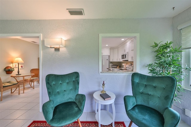 sitting room featuring light tile patterned floors