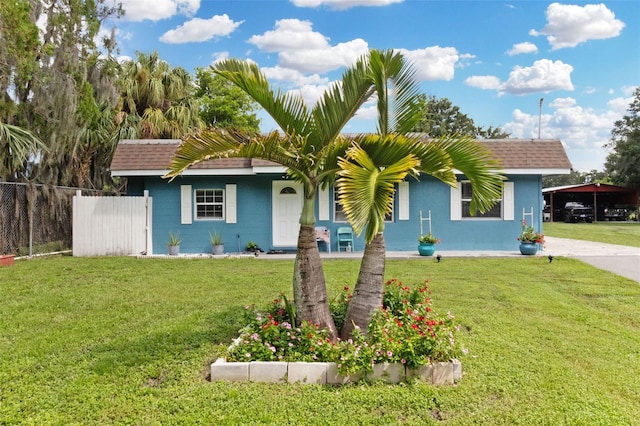 single story home with a front lawn and a carport