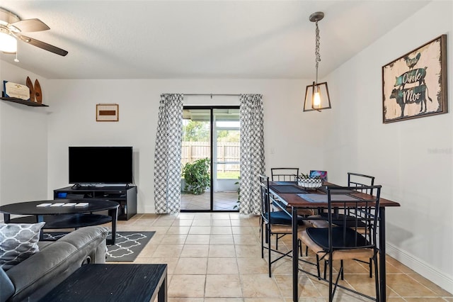 tiled dining area with a textured ceiling and ceiling fan