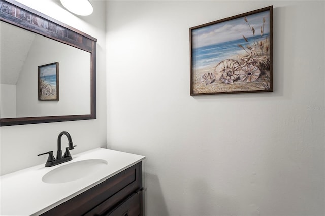 bathroom with vanity and lofted ceiling