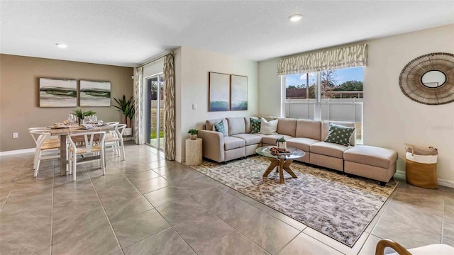 living room featuring a textured ceiling and light tile patterned floors