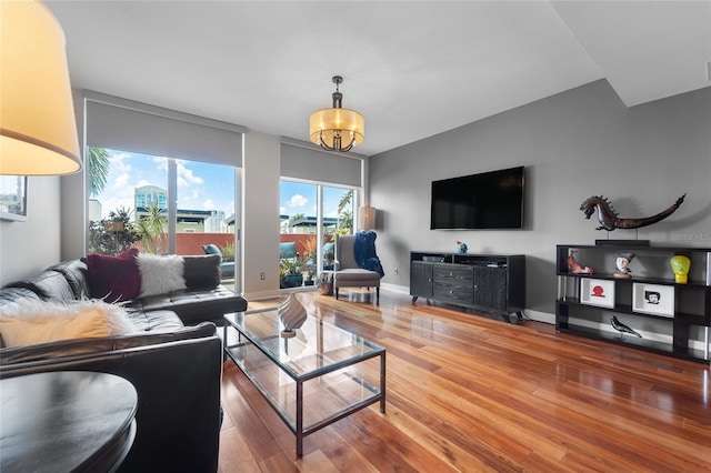 living room with wood-type flooring and a chandelier